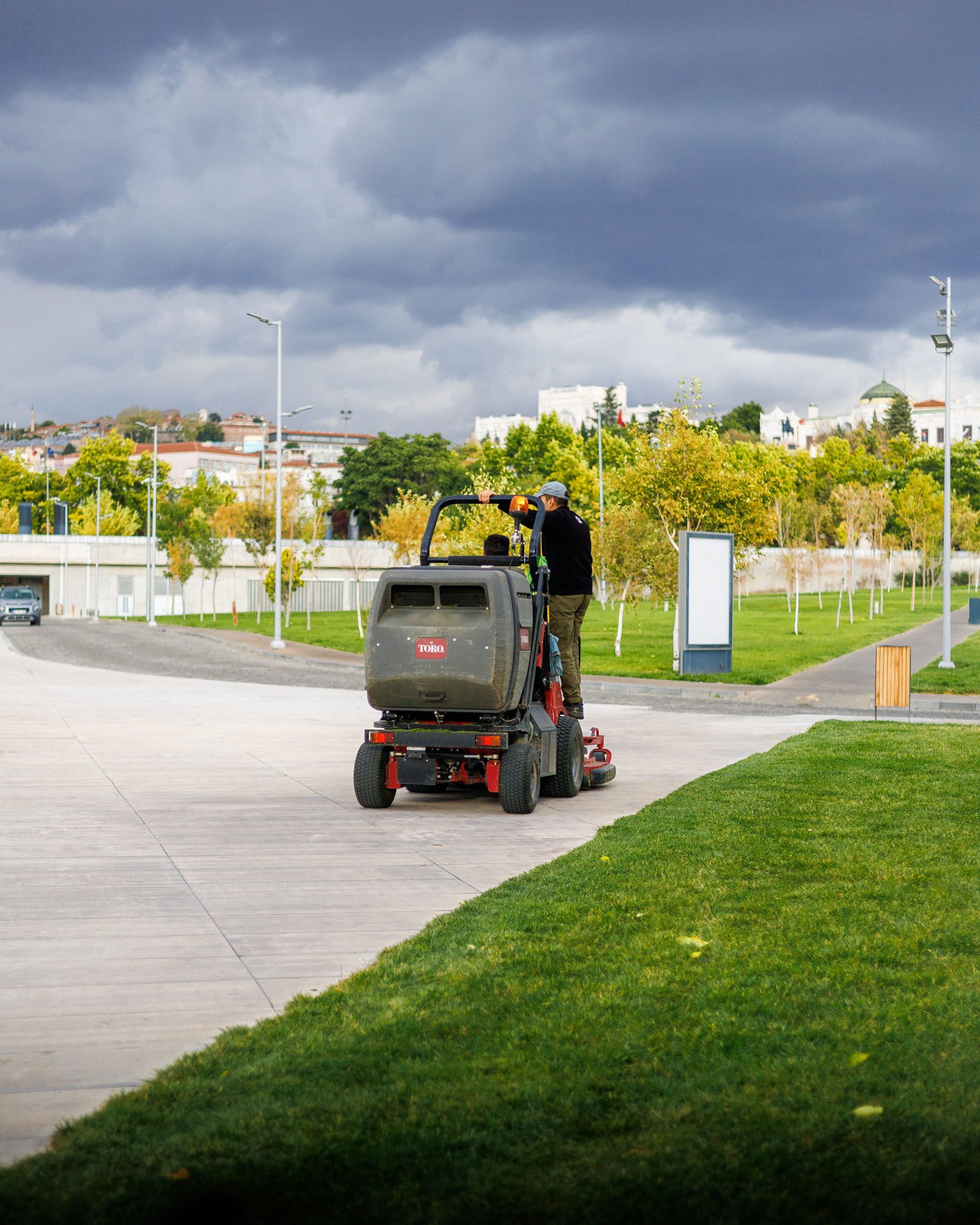 Technician power brooming artificial turf